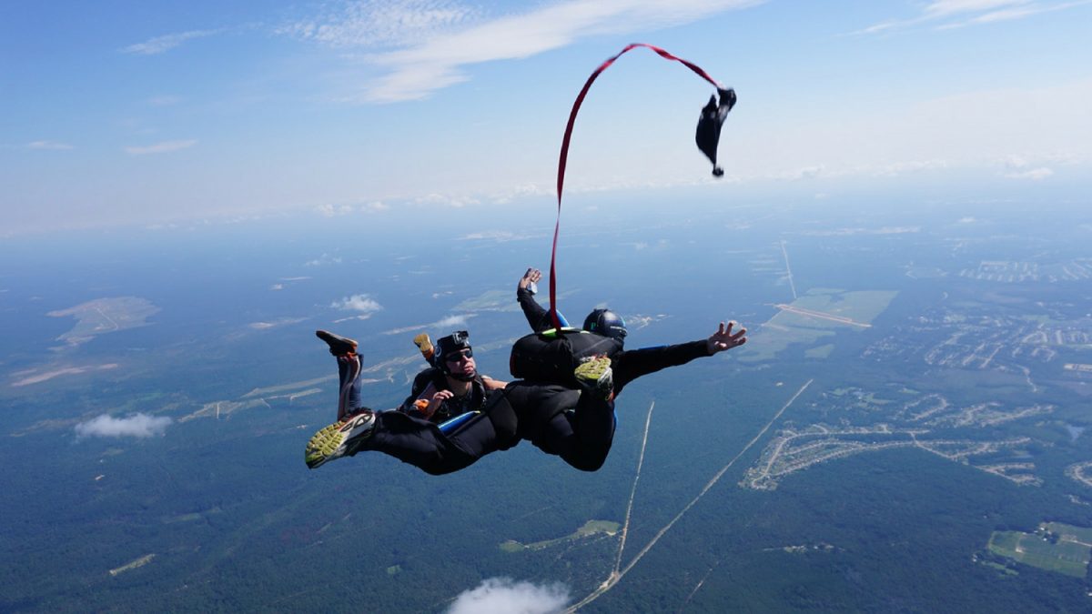 student deploys their own parachute during skydiving course