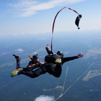 student deploys their own parachute during skydiving course