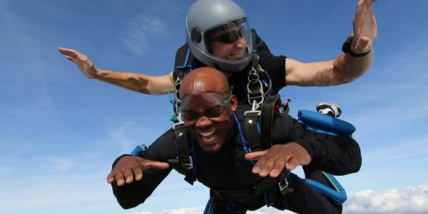 young man makes a tandem skydive
