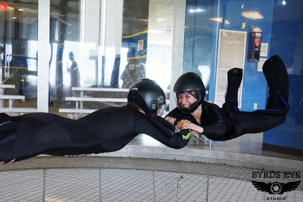 two experienced flyers practice bodyflight skills in wind tunnel