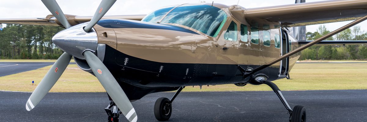 Skydive Paraclete XP's gold and black skydiving Caravan airplane.