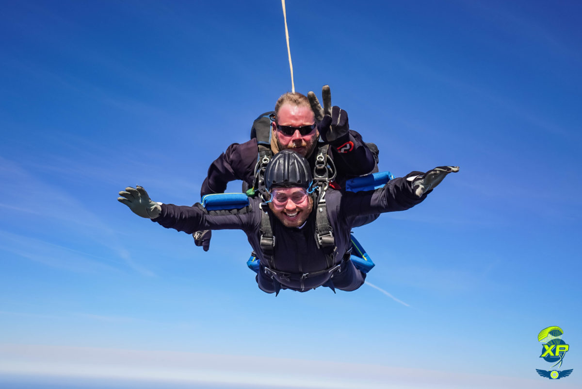A tandem student smiling while making a tandem skydive