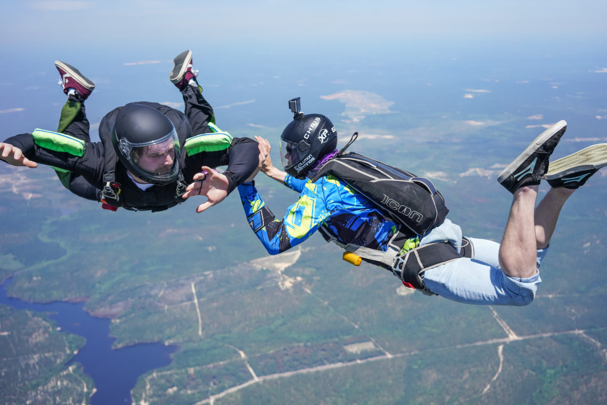 AFF skydiving instructor holds onto student skydiver in freefall 