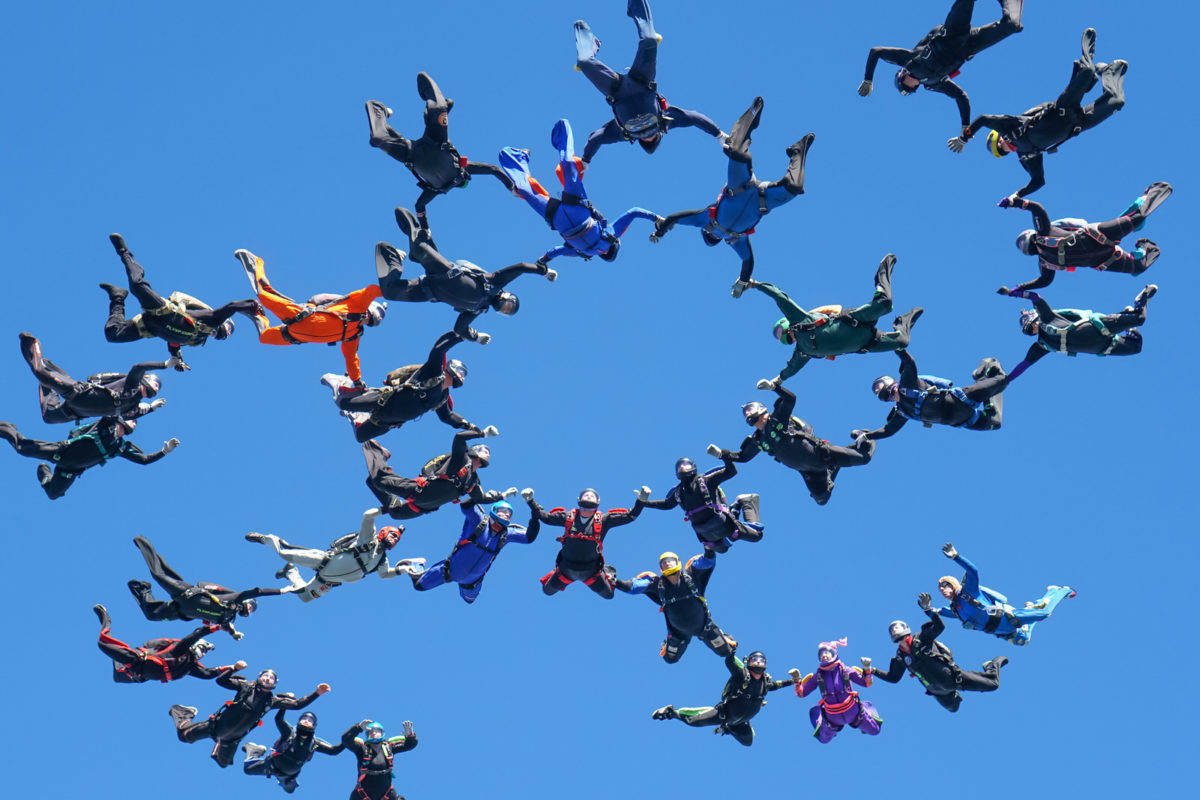 Group of skydivers belly formation skydiving in freefall 