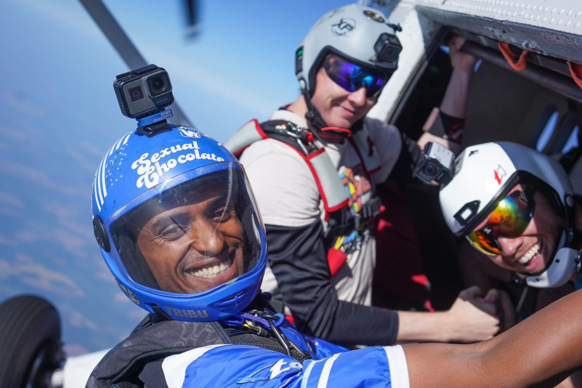 Skydivers in door of airplane about to exit into freefall