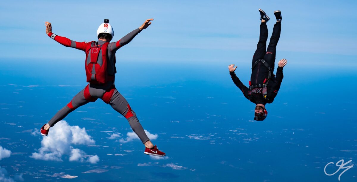 Two skydivers in freefall, one flying head-down and one head-up 