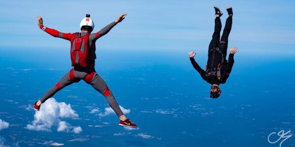 Two skydivers in freefall, one flying head-down and one head-up